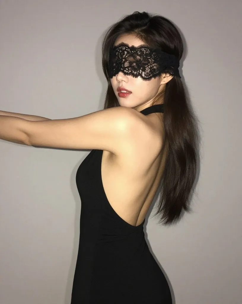 등이 파인 검은 원피스를 입고 선 여성
